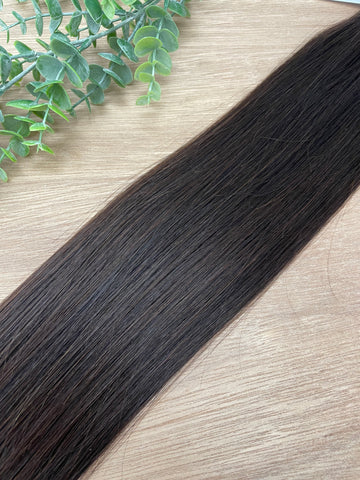 CLOVE HIBER WEFT Clove Hiber Weft is a 22" weft is a natural deep level 3 warm brown with a copper undertone. These wefts offer customization options, including custom sizing, cut, and a seamless fine root base without a return edge. The Hiber Wefts are 2