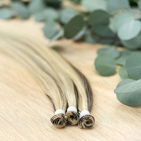 ALDER INDIVIDUAL HANDTIED WEFT Alder is a 22" weft featuring piano natural toned level 7 ash and a neutral level 10 warm blonde. Our hand-tied wefts are 22" in length and 11" in width, providing ample coverage for a voluminous result. Each individual weft