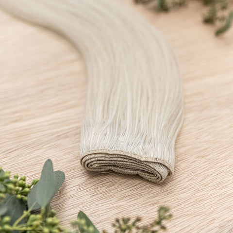 ASPEN MACHINE WEFT 50g Aspen machine weft is a 22" weft featuring natural-toned level 10 ash platinum blonde. These machine wefts offer the highest weft density, along with the flexibility to be custom sized, colored, and cut according to your preferences
