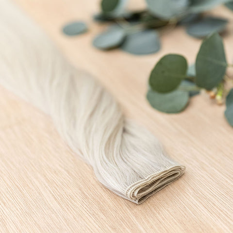 ASPEN HIBER WEFT Aspen Hiber Weft is a 22" weft is a natural level 10 ash platinum blonde shade. These wefts offer customization options, including custom sizing, cut, and a seamless fine root base without a return edge. The Hiber Wefts are 22" in length