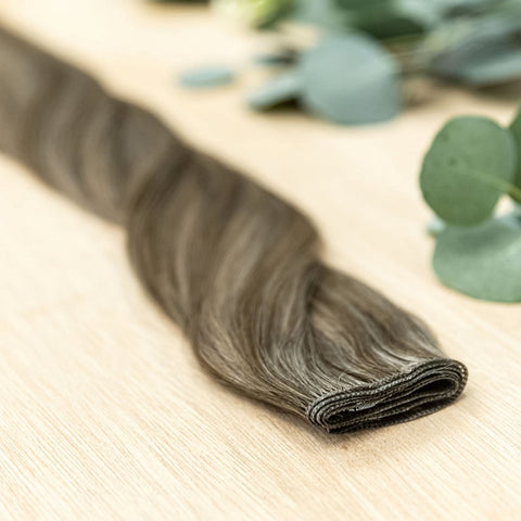 CYPRESS HIBER WEFT Cypress Hiber Weft is a 22" piano weft featuring natural-toned level 4 brown and neutral level 8 ash blonde. These wefts offer customization options, including custom sizing, cut, and a seamless fine root base without a return edge. The