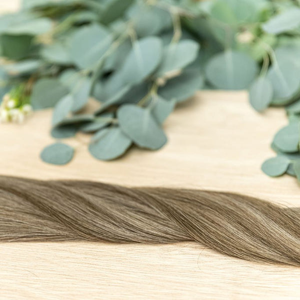 CYPRESS HIBER WEFT Cypress Hiber Weft is a 22" piano weft featuring natural-toned level 4 brown and neutral level 8 ash blonde. These wefts offer customization options, including custom sizing, cut, and a seamless fine root base without a return edge. The