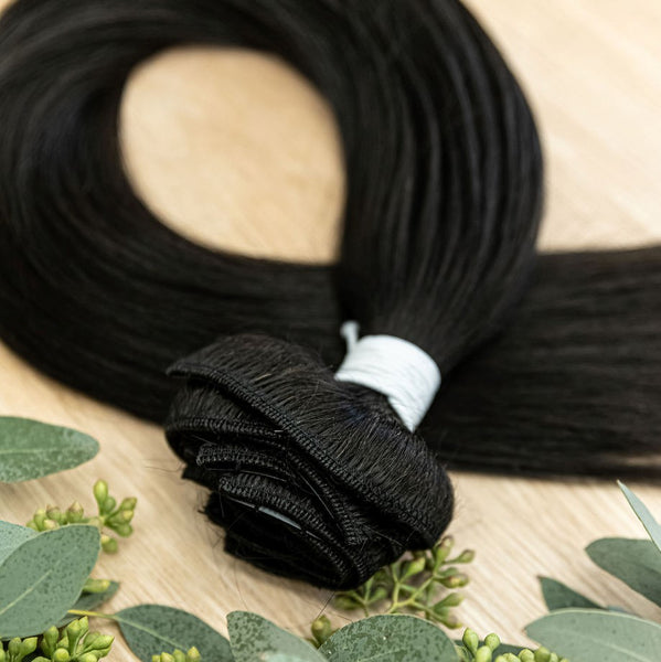 EBONY CLIP IN Ebony clip-in hair extensions are 22 inches in length and made of a gorgeous weft of natural-toned level 1 dark brown, warm undertone. They provide instant density and length when applied to the hair. These clip-in extensions can be customiz
