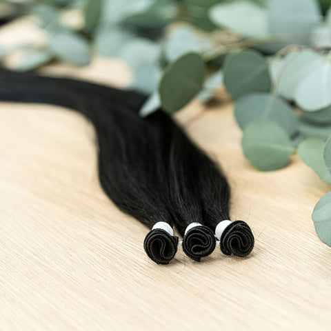 EBONY INDIVIDUAL HANDTIED WEFT Ebony is a 22" weft featuring natural level 1 dark brown with a warm undertone. Our hand-tied wefts are 22" in length and 11" in width, providing ample coverage for a voluminous result. Each individual weft weighs 20 grams,