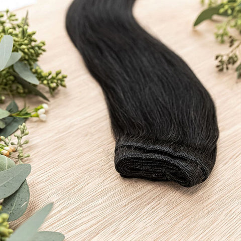EBONY MACHINE WEFT 50g Ebony machine weft is a 22" weft featuring natural-toned level 1 brown with warm undetone. These machine wefts offer the highest weft density, along with the flexibility to be custom sized, colored, and cut according to your prefere