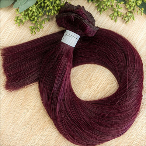 GARNET CLIP IN Garnet clip-in hair extensions are 22 inches in length and made of a gorgeous weft of vibrant toned level 5 red violet. They provide instant density and length when applied to the hair. These clip-in extensions can be customized in terms of