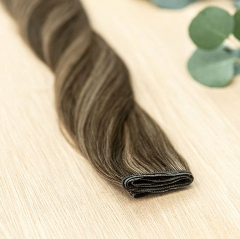 HICKORY HIBER WEFT Hickory Hiber Weft is a 22" piano weft featuring natural-toned level 2 brown and neutral level 8 warm blonde. These wefts offer customization options, including custom sizing, cut, and a seamless fine root base without a return edge. Th