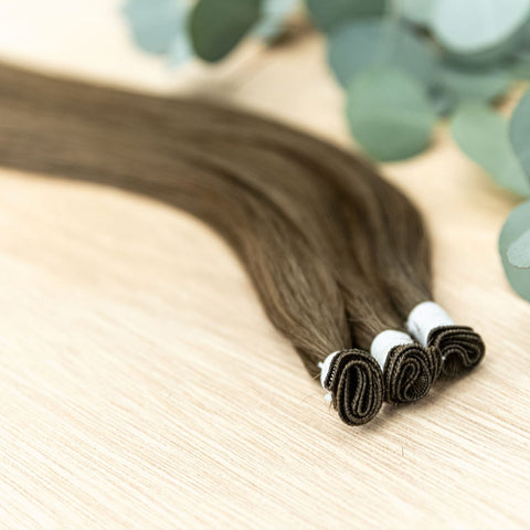JUNIPER INDIVIDUAL HANDTIED WEFT Juniper is a 22" weft featuring natural level 5 warm brown. Our hand-tied wefts are 22" in length and 11" in width, providing ample coverage for a voluminous result. Each individual weft weighs 20 grams, ensuring lightweig