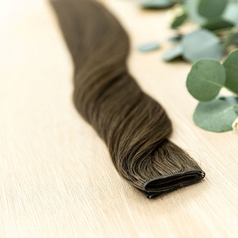 LINDEN HIBER WEFT Linden Hiber Weft is a 22" weft is a natural level 2 ash brown. These wefts offer customization options, including custom sizing, cut, and a seamless fine root base without a return edge. The Hiber Wefts are 22" in length and 32" in widt