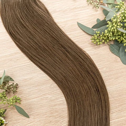 JUNIPER NATURAL TAPE Juniper weft is a 22" weft featuring natural-toned level 5 warm brown. Our natural tape hair extensions are carefully crafted to ensure a natural appearance and seamless blending. The hair is placed on the outside of the tape, allowin