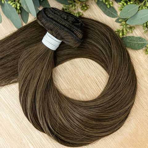 LINDEN CLIP IN Linden clip-in hair extensions are 22 inches in length and made of a gorgeous weft of natural-toned level 4 ash brown ash. They provide instant density and length when applied to the hair.These clip-in extensions can be customized in terms