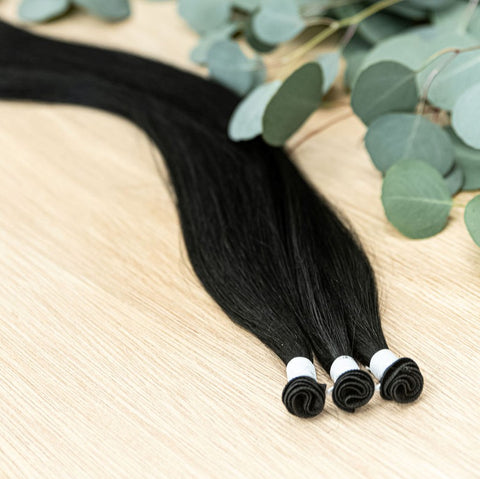 RAVEN INDIVIDUAL HANDTIED WEFT Raven is a 22" weft featuring natural level 1 black with blue base undertone. Our hand-tied wefts are 22" in length and 11" in width, providing ample coverage for a voluminous result. Each individual weft weighs 20 grams, en