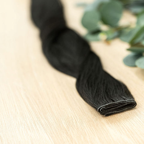 RAVEN HIBER WEFT Raven Hiber Weft is a 22" weft is a natural level 1 blue black base. These wefts offer customization options, including custom sizing, cut, and a seamless fine root base without a return edge. The Hiber Wefts are 22" in length and 32" in