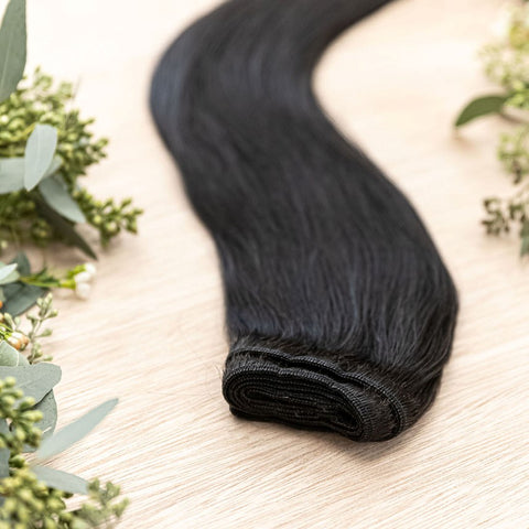 RAVEN MACHINE WEFT 50g Raven machine weft is a 22" weft featuring natural-toned level 1 blue black base. These machine wefts offer the highest weft density, along with the flexibility to be custom sized, colored, and cut according to your preferences. The