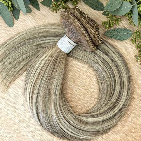 ALDER CLIP IN - ROOTED Alder rooted clip-in hair extensions are 22 inches in length and made of a gorgeous weft of natural-toned level 7 ash and neutral level 10 warm blonde- rooted in a natural level 8. They provide instant density and length when applie