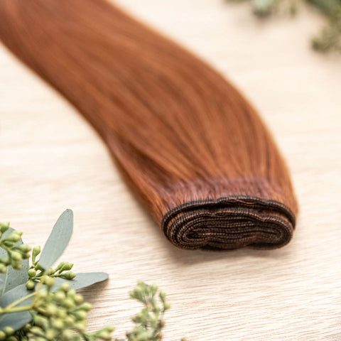 SAFFRON MACHINE WEFT 50g Saffron machine weft is a 22" weft featuring natural-toned level 6 vivid warm copper. These machine wefts offer the highest weft density, along with the flexibility to be custom sized, colored, and cut according to your preference