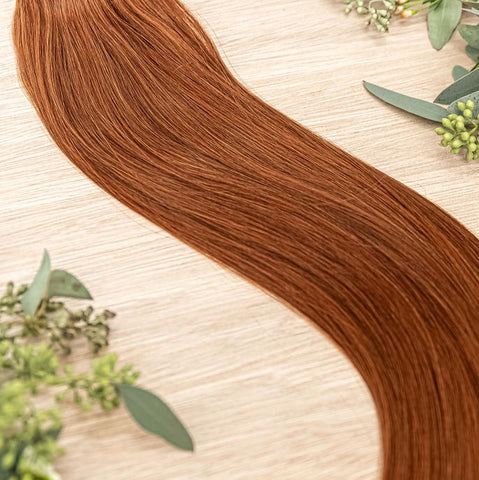 SAFFRON NATURAL TAPE Saffron weft is a 22" piano weft featuring natural-toned level 6 vivid warm copper. Our natural tape hair extensions are carefully crafted to ensure a natural appearance and seamless blending. The hair is placed on the outside of the